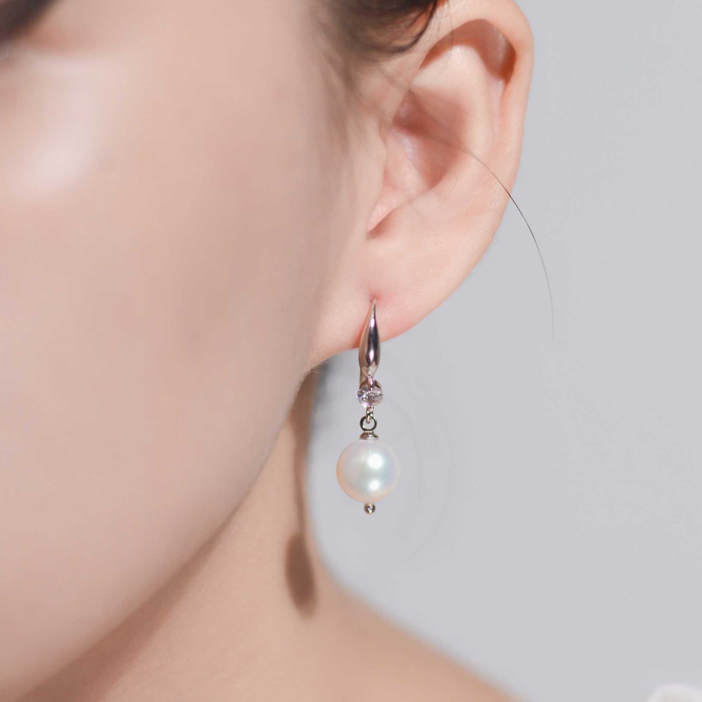 9.5 mm white semi-round pearl dangling rhodium plated with zircon earrings