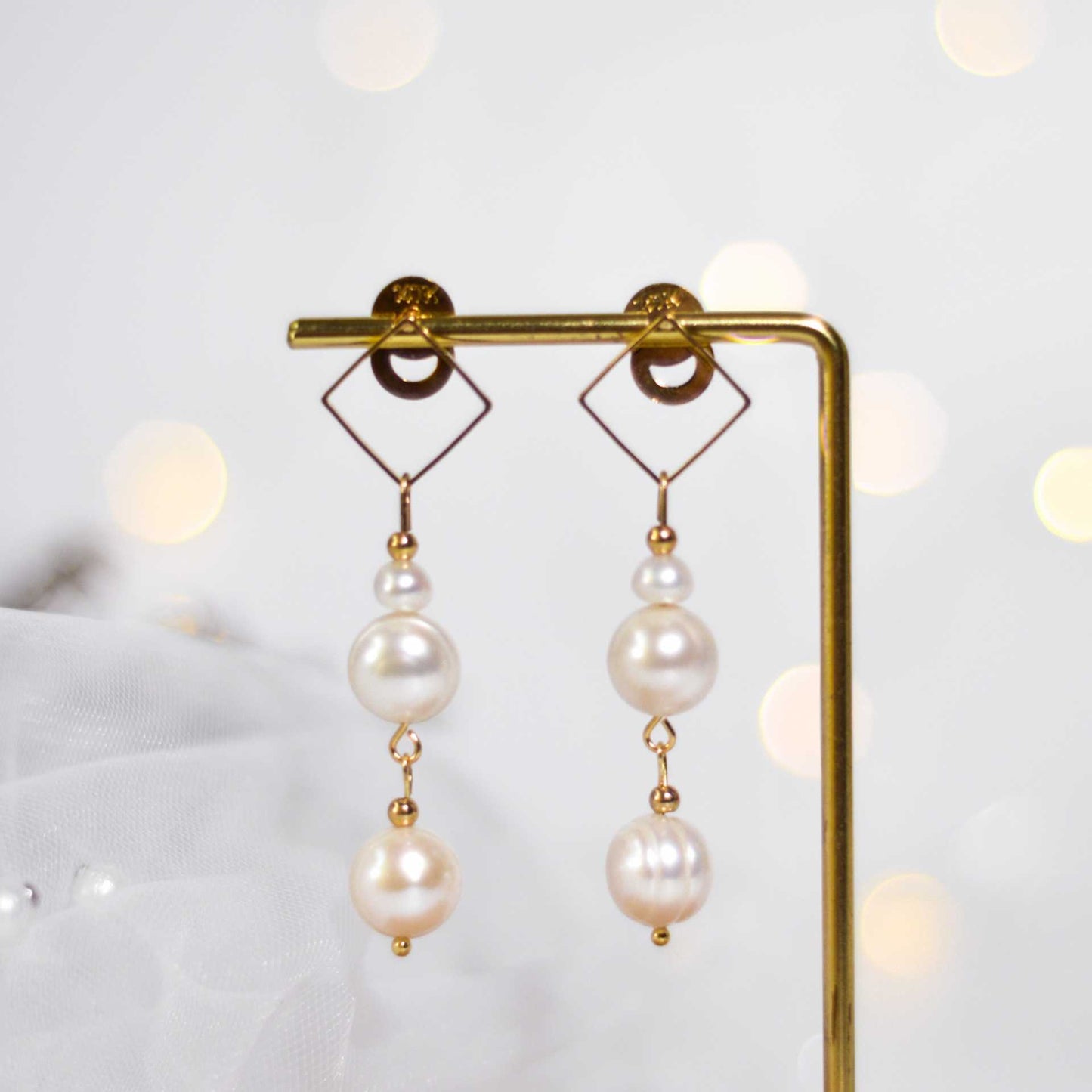 Multi-tier white siopao and round pearls diamond-shaped dangling yellow gold plated earrings
