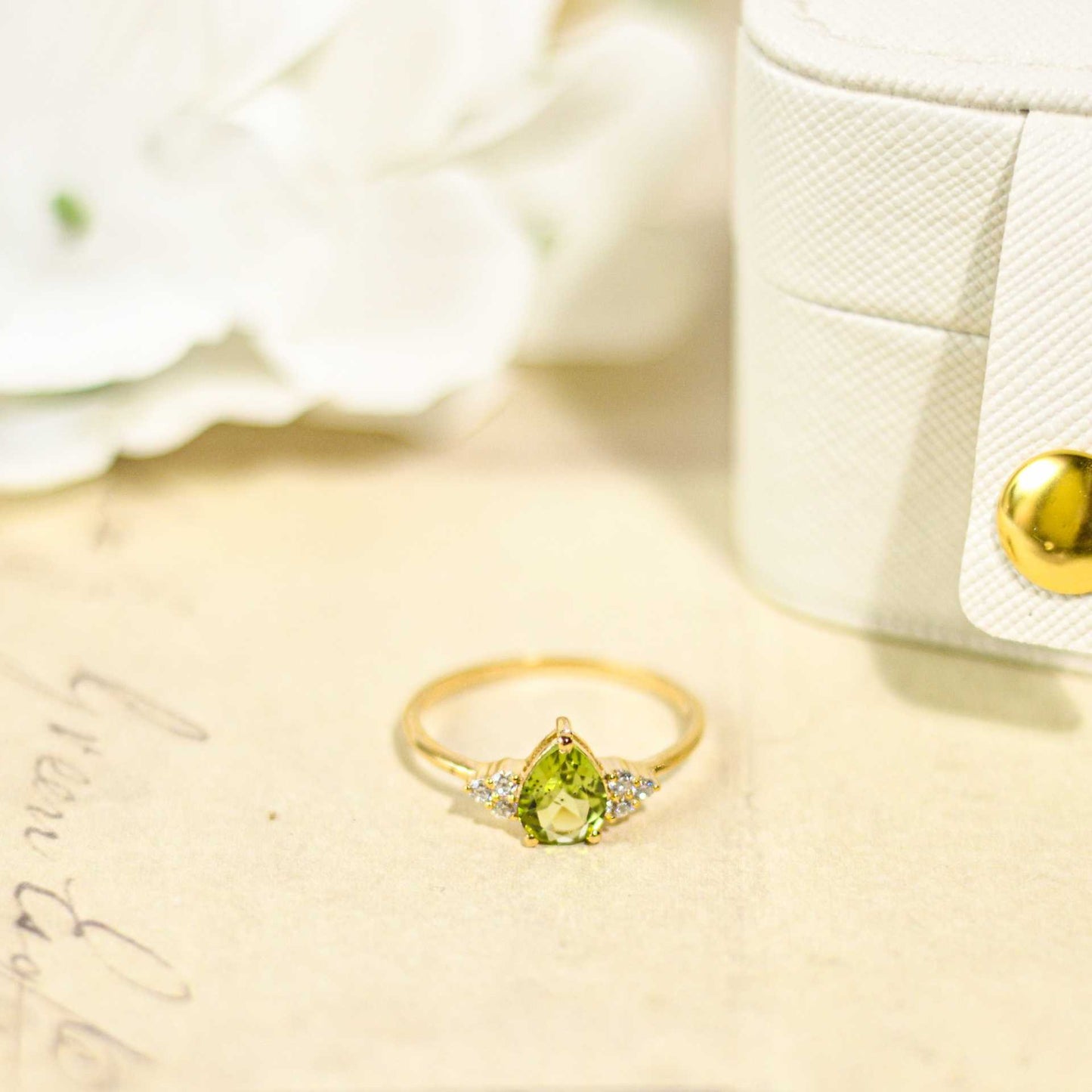 8 x 6 mm Pear cut Peridot with 3 Cz side stones Ring