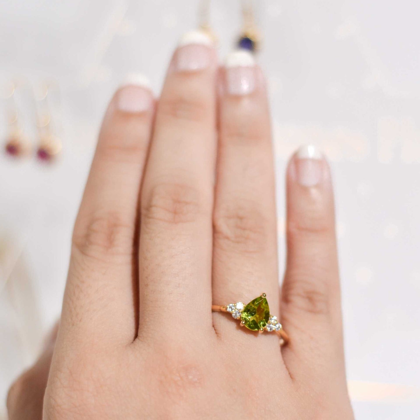 8 x 6 mm Pear cut Peridot with 3 Cz side stones Ring