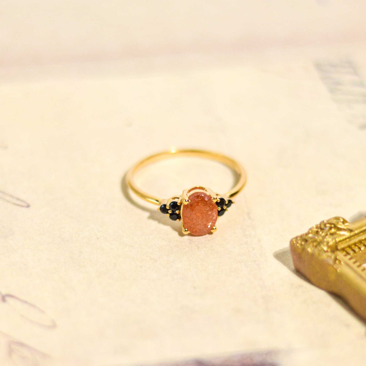 8 x 6 mm Oval cut Sunstone with 3 Black Spinel side stones Ring