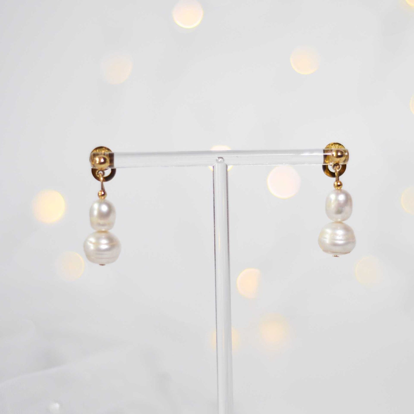 White oval and siopao dangling pearls yellow gold plated earrings