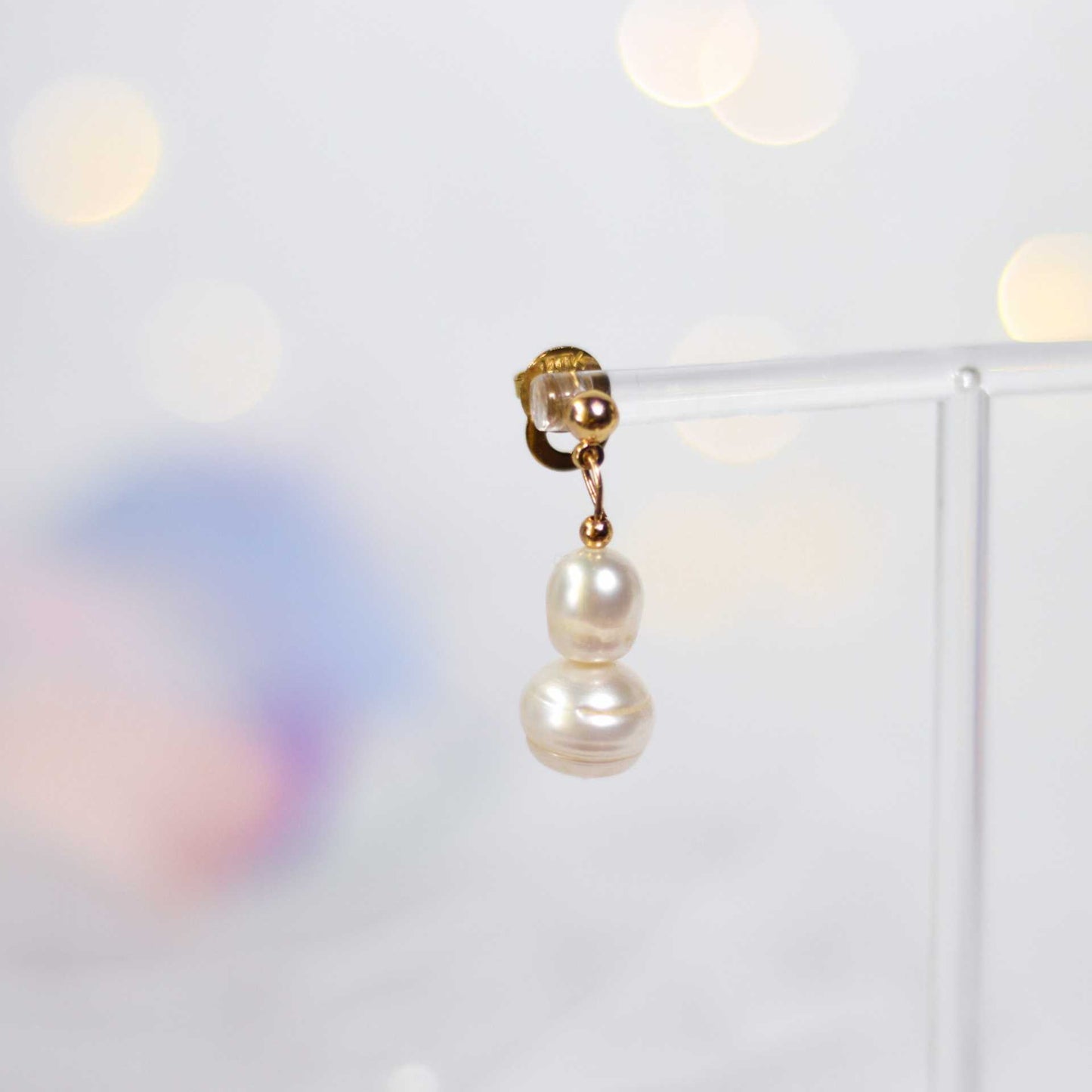 White oval and siopao dangling pearls yellow gold plated earrings
