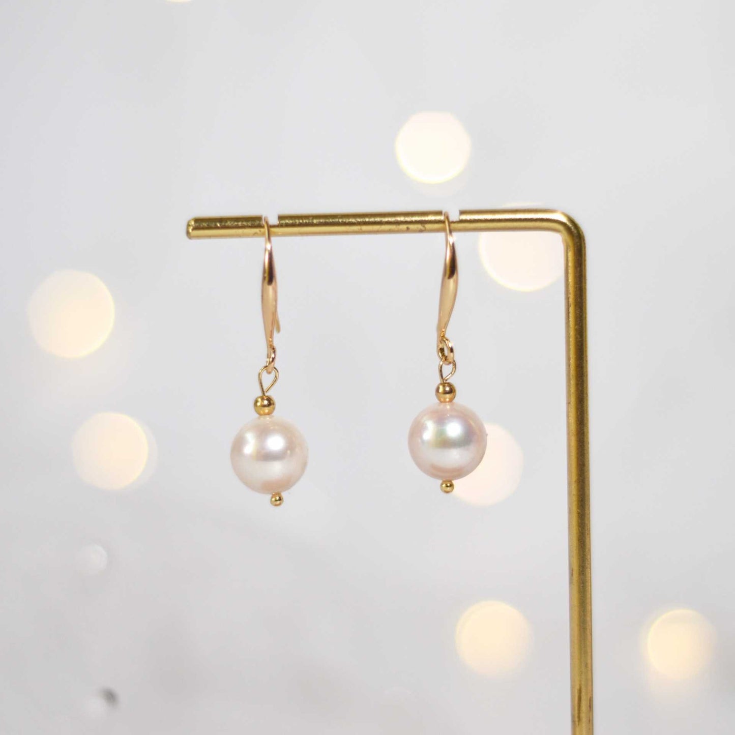 10.5 mm white round pearl yellow gold plated dangling earrings