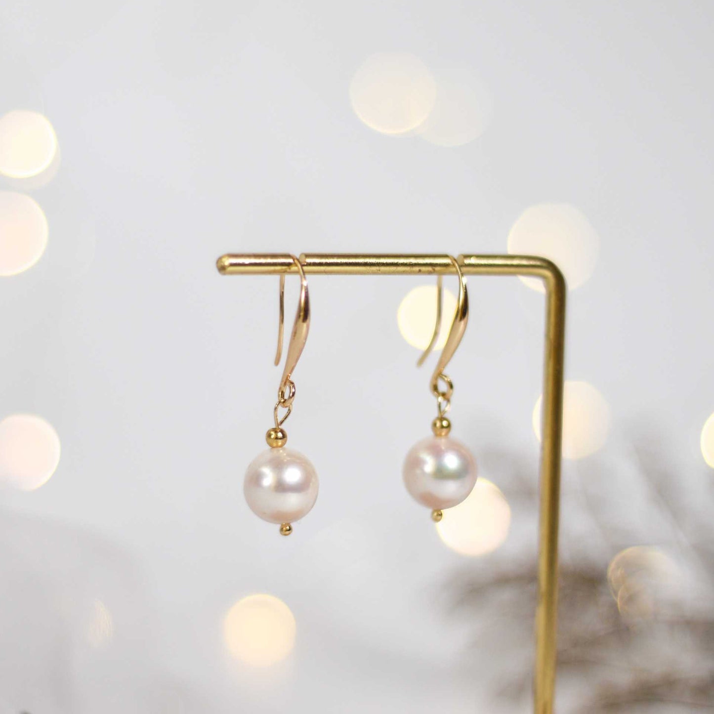 10.5 mm white round pearl yellow gold plated dangling earrings