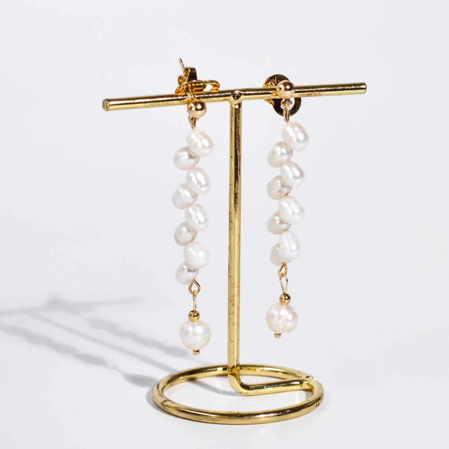 8 pcs. White dancing pearls with 7.8 mm semi-round pearl yellow gold plated dangling earrings