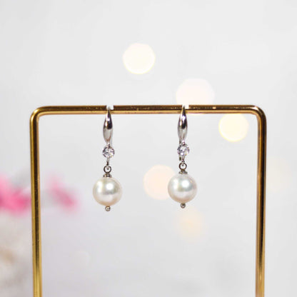 9.5 mm white semi-round pearl dangling rhodium plated with zircon earrings
