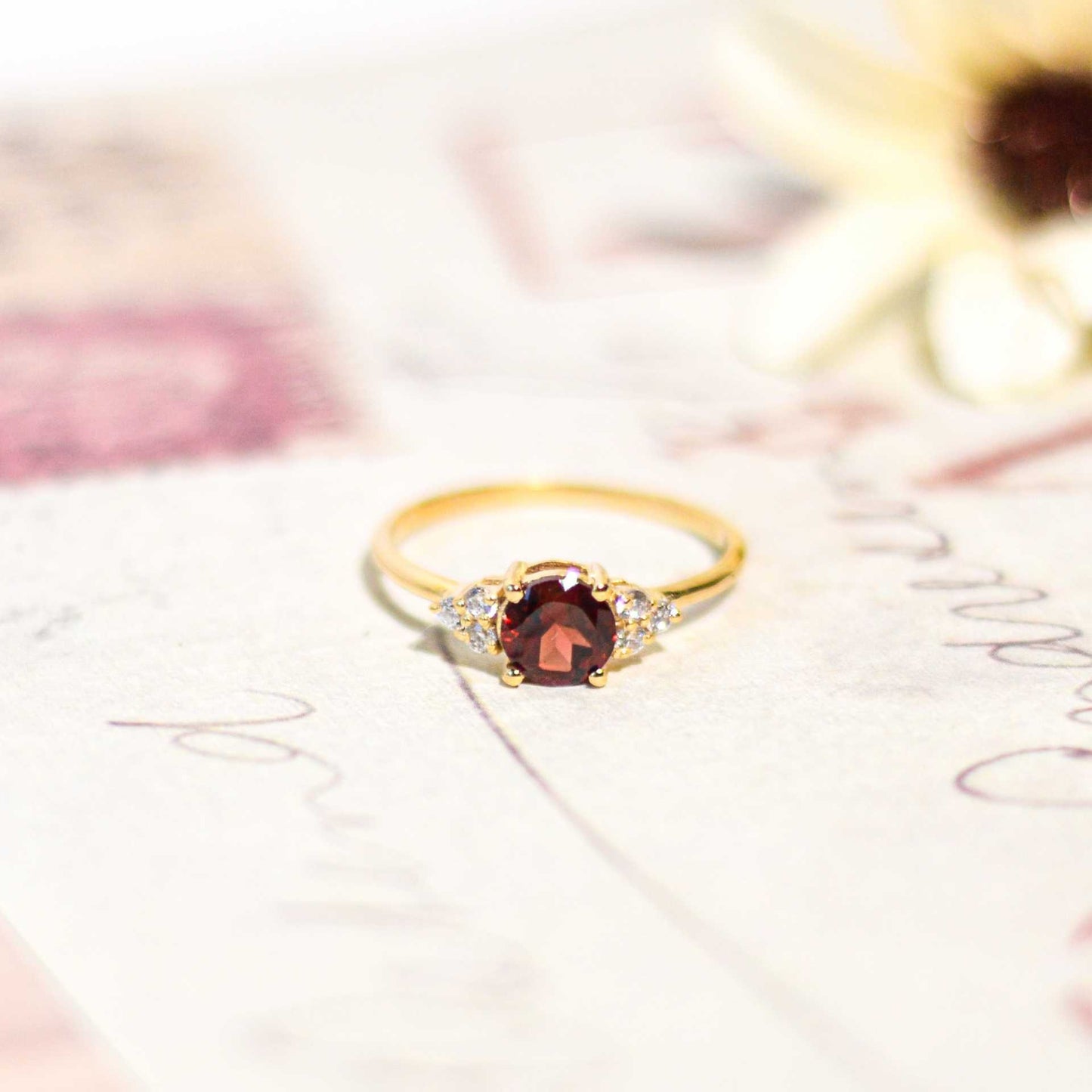 6 mm Round cut Red Garnet with 3 Cz side stones Ring