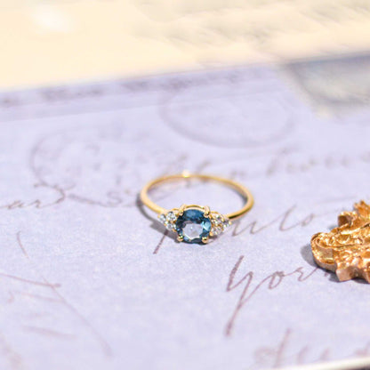 6 mm Round cut London Blue Topaz with 3 Cz side stones Ring