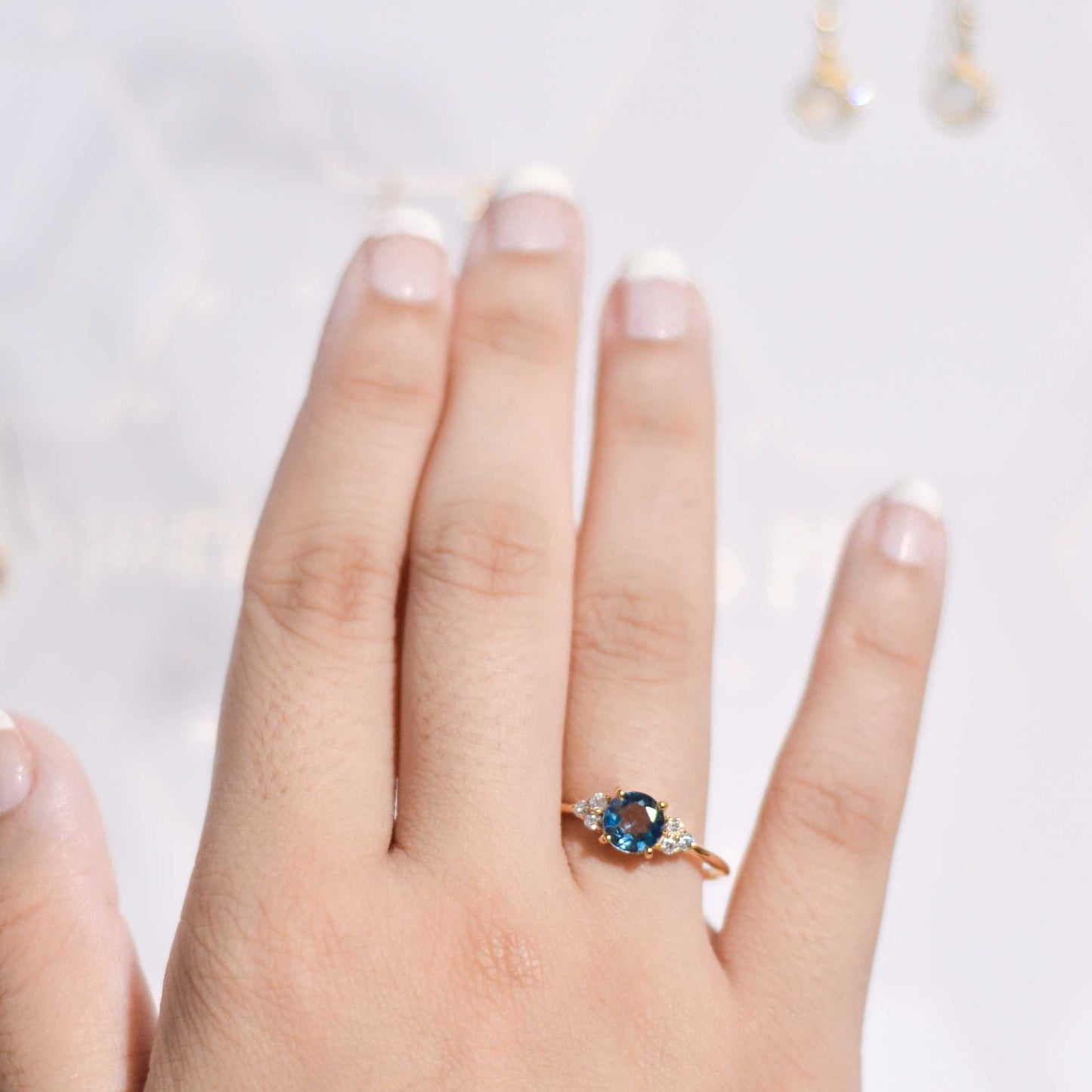 6 mm Round cut London Blue Topaz with 3 Cz side stones Ring