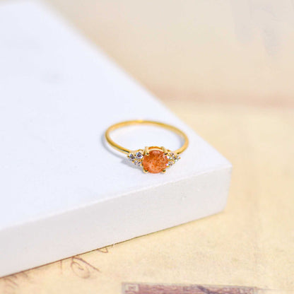 6 mm Round cut Sunstone with 3 Cz side stones Ring