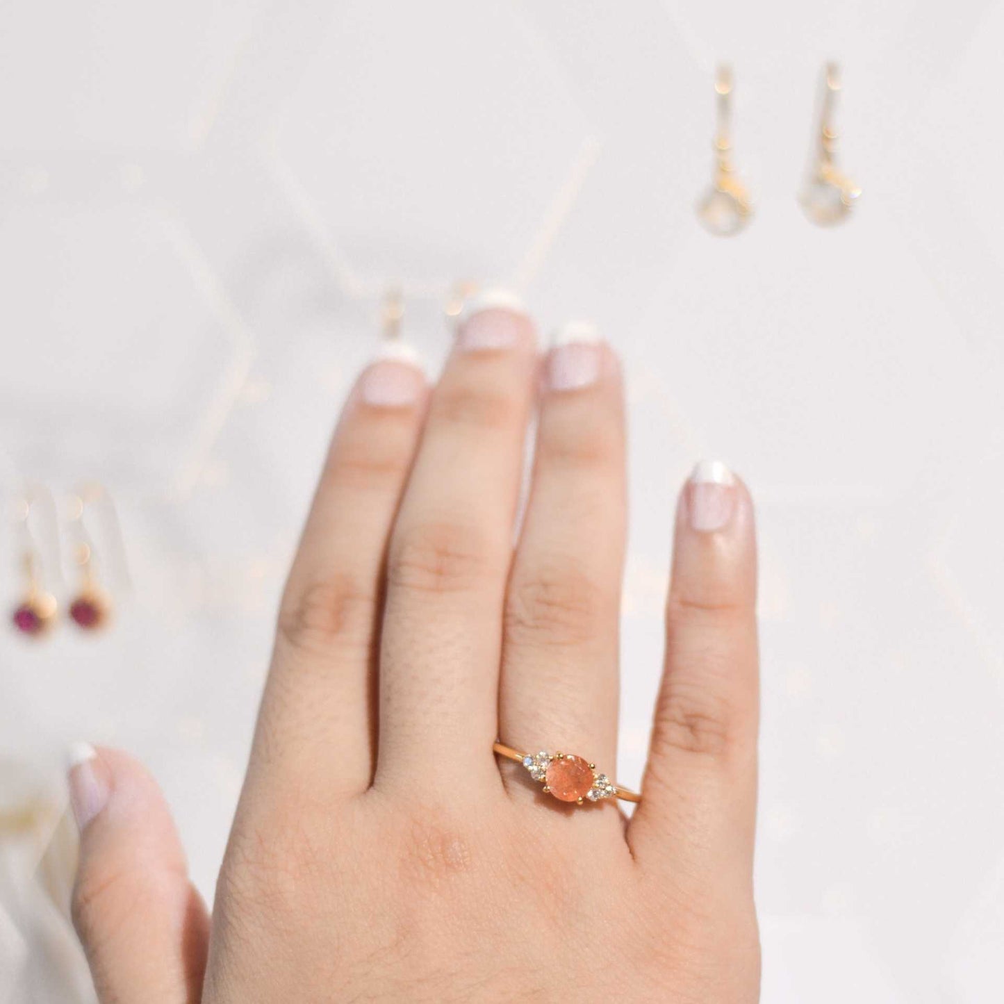 6 mm Round cut Sunstone with 3 Cz side stones Ring