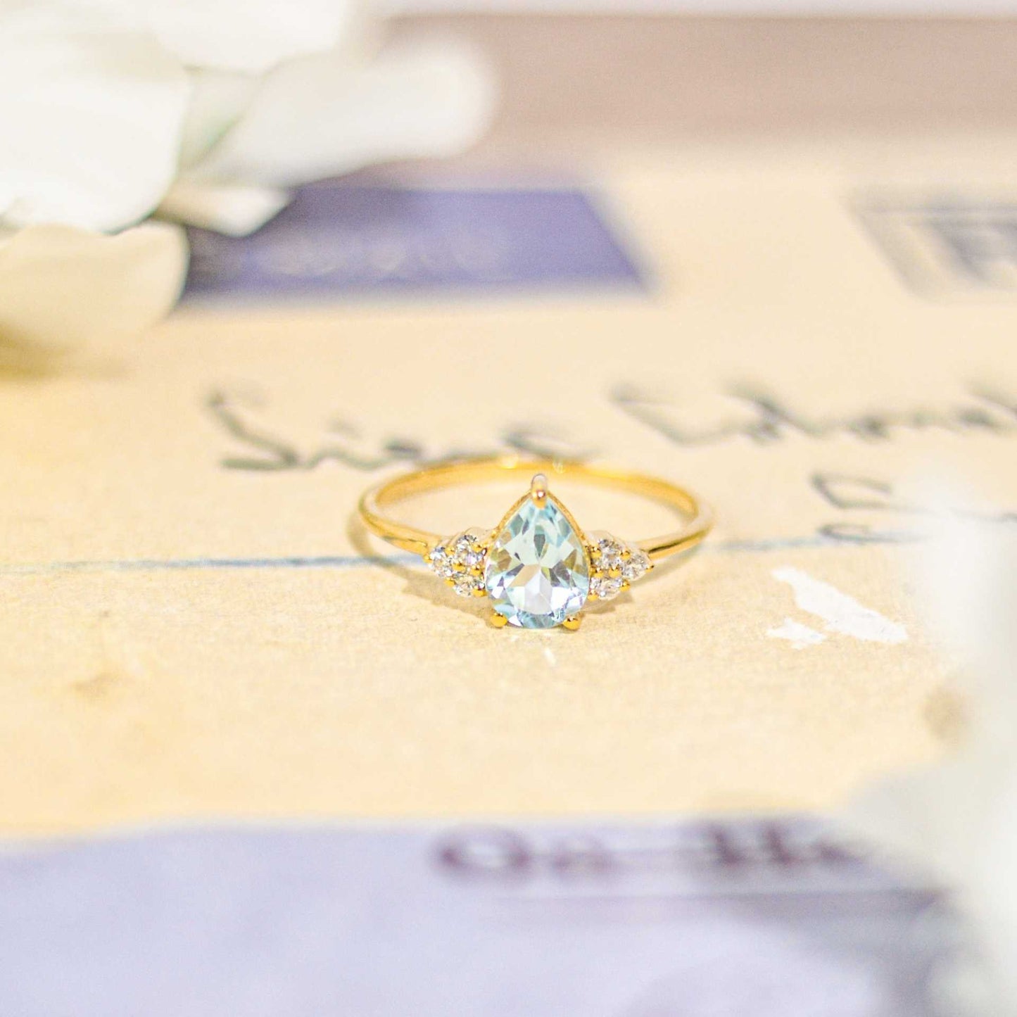 8 x 6 mm Pear cut Swiss Blue Topaz with 3 Cz side stones Ring