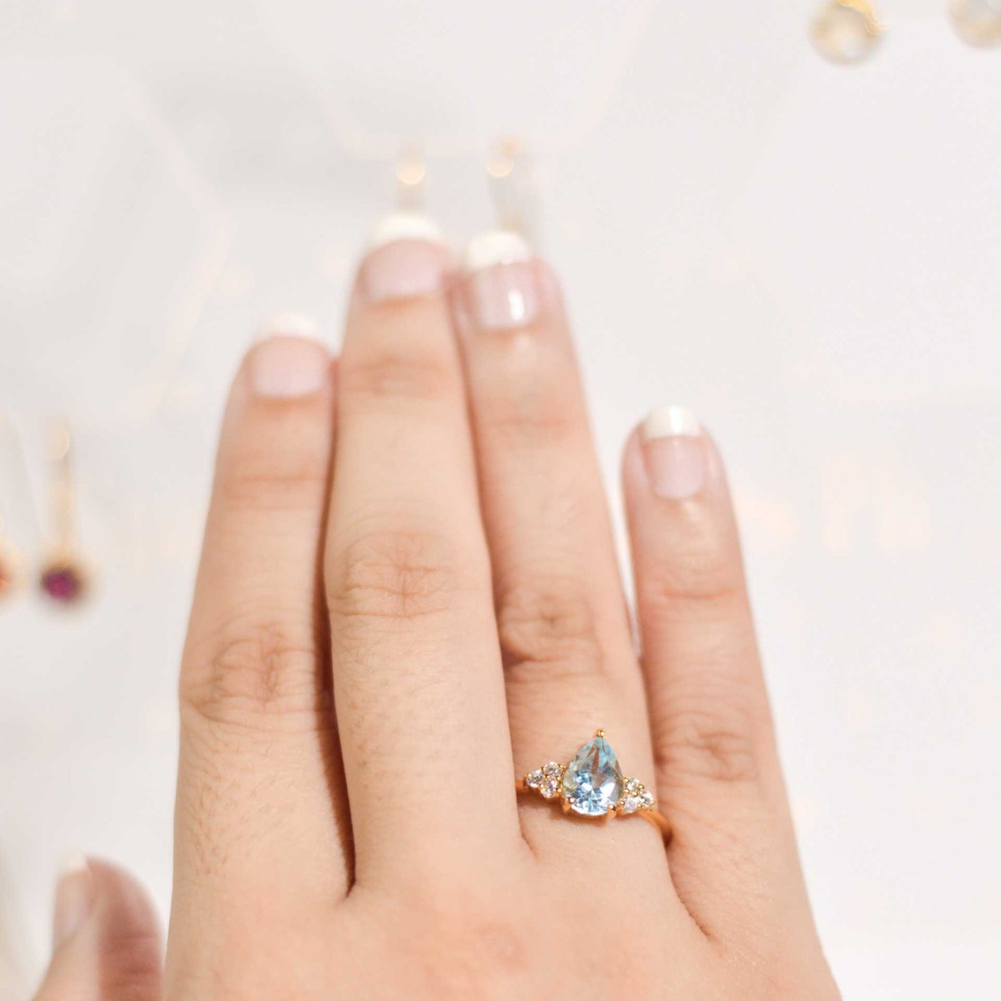 8 x 6 mm Pear cut Swiss Blue Topaz with 3 Cz side stones Ring