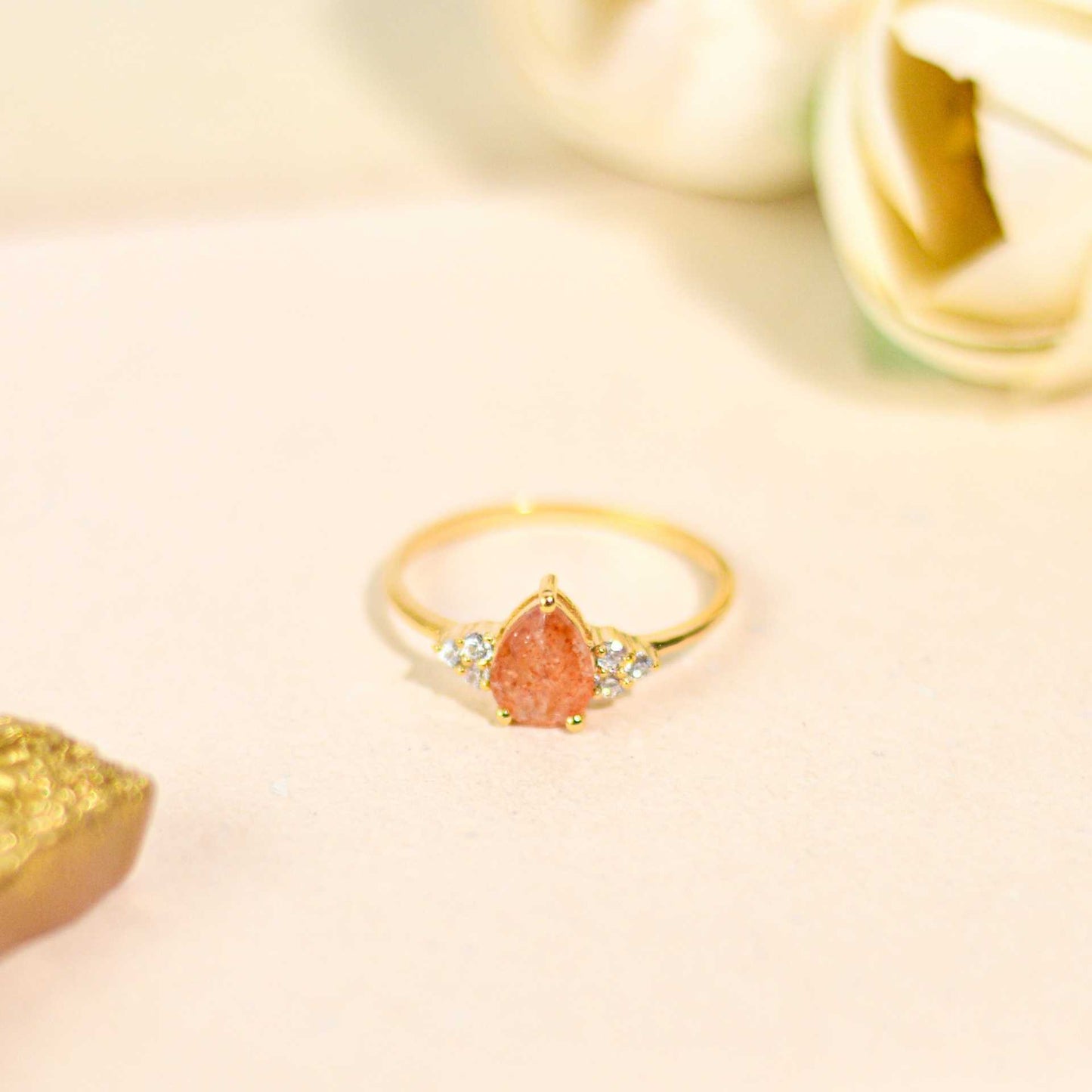 8 x 6 mm Pear cut Sunstone with 3 Cz side stones Ring