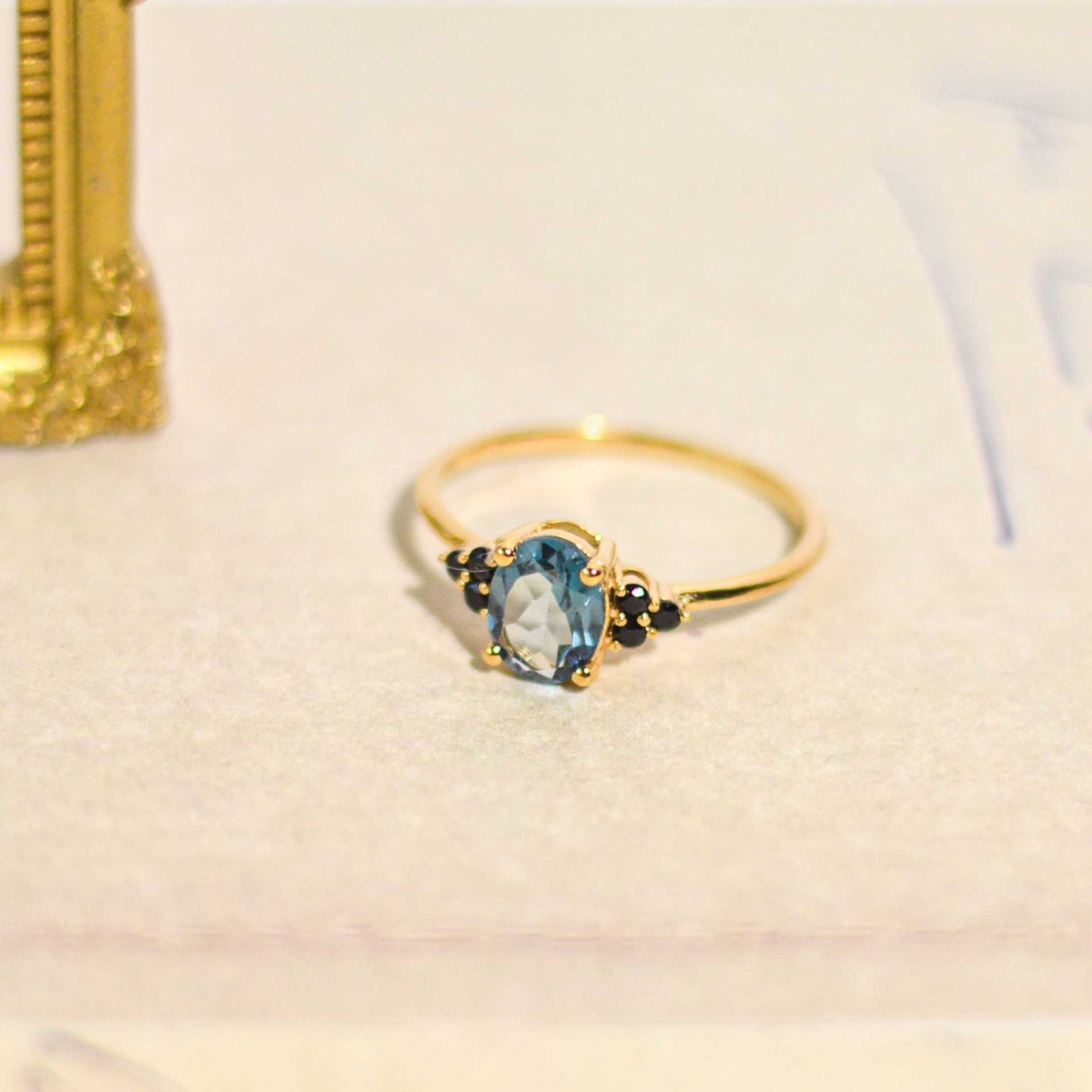8 x 6 mm Oval cut London Blue Topaz with 3 Black Spinel side stones Ring