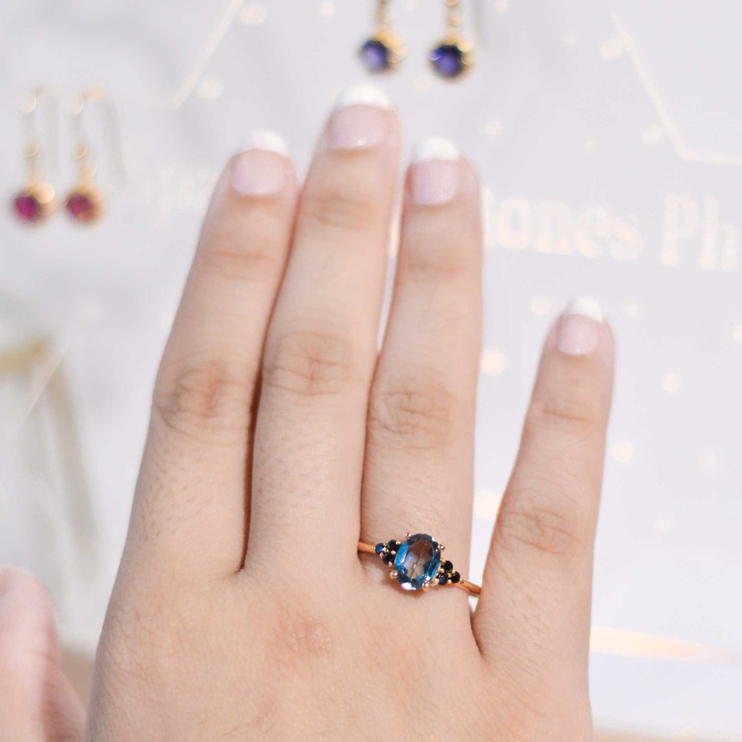8 x 6 mm Oval cut London Blue Topaz with 3 Black Spinel side stones Ring