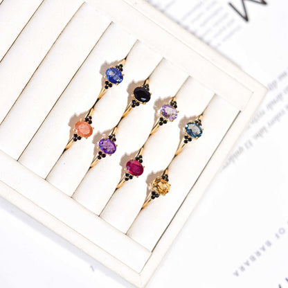 8 x 6 mm Oval cut London Blue Topaz with 3 Black Spinel side stones Ring